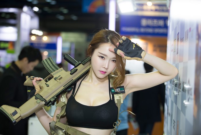 Asian woman with assault rifle