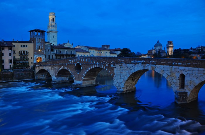 Ponte Pietra bridge over Adige River in Verona at night
