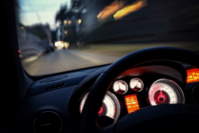 Car dashboard and steering wheel at night