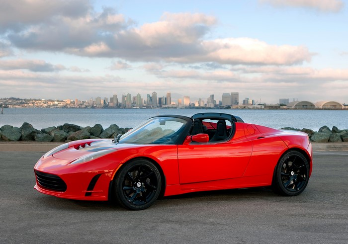 Red Tesla Roadster Sport Cabriolet by the water