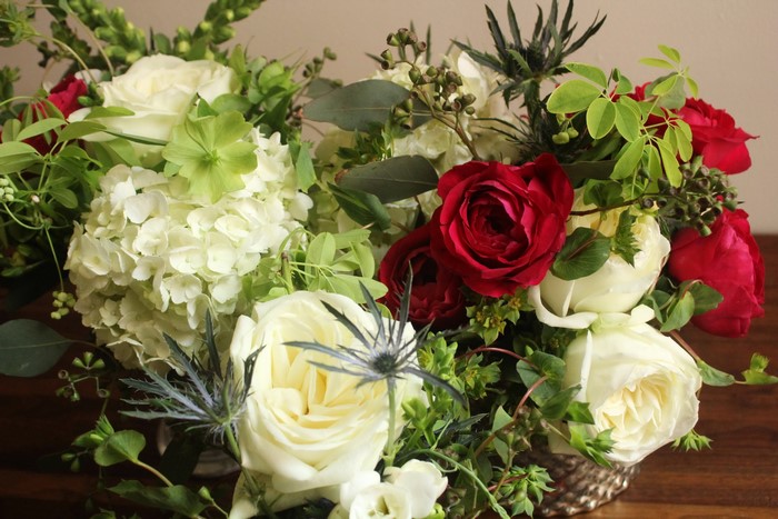 Red and white roses with hydrangeas and greenery