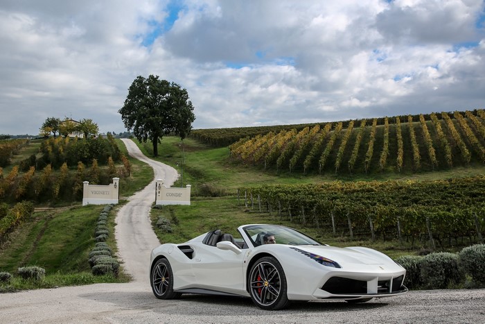 White Ferrari 488 Spider convertible in vineyard