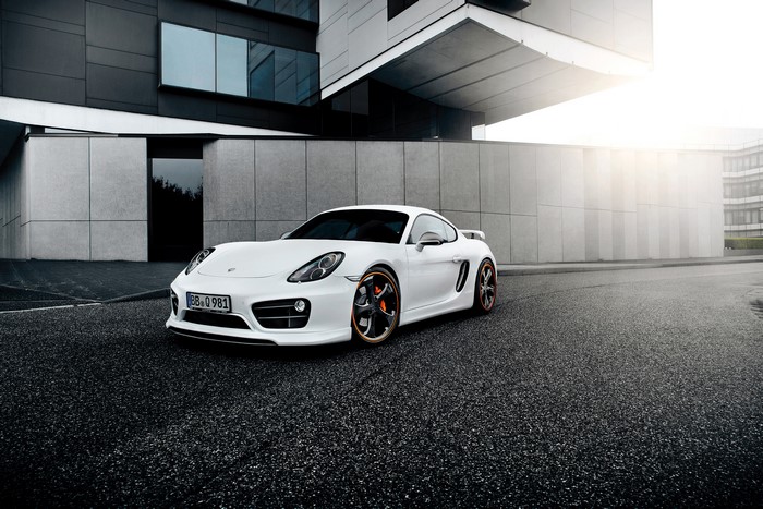 White TechArt Porsche Cayman S (981C) parked outside modern building