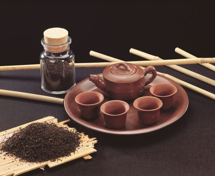 Tea set with teapot, cups, and loose tea