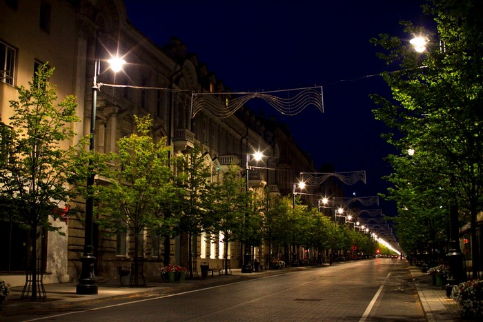 Street lights illuminate a European city street at night