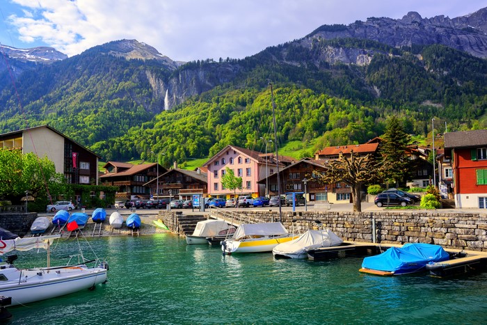 Boats docked on Lake Interlaken, Switzerland with mountains