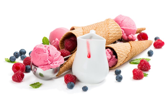 Pink ice cream with berries and cones