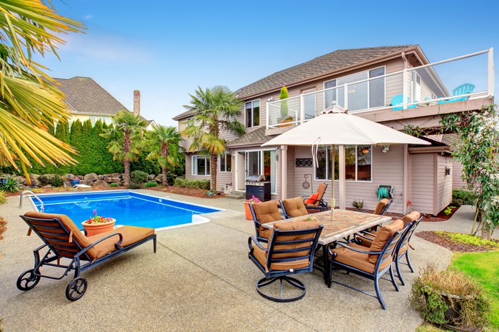 Backyard with swimming pool and patio furniture