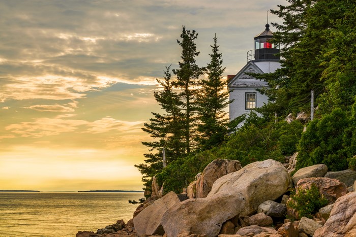 Bass Harbor Lighthouse on rocky coast at sunset