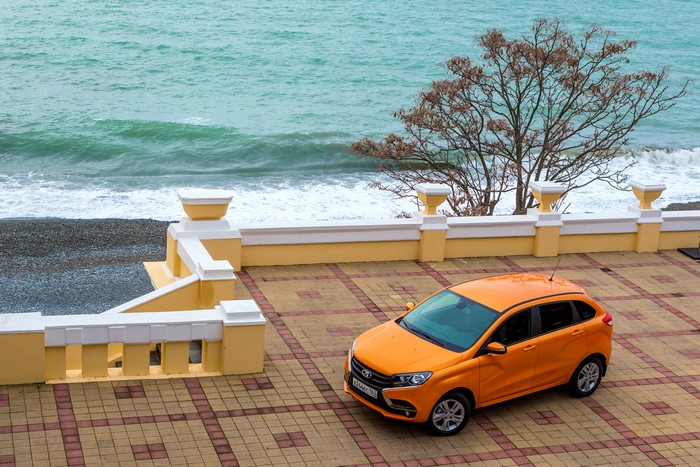 Orange Lada XRAY car by the sea