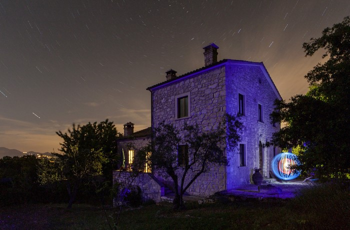Stone house at night with light painting