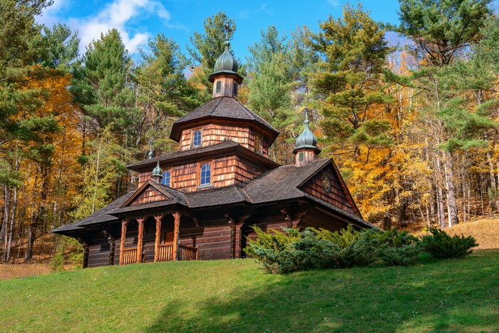 Old wooden Ukrainian church in autumn forest