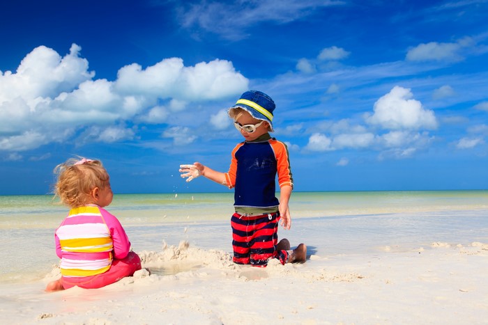 Two children playing on a sandy beach