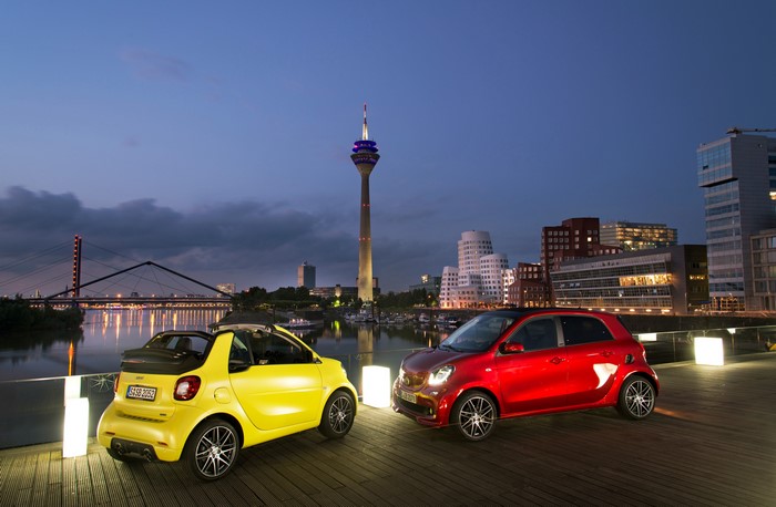 Two Smart Cars by a River at Dusk