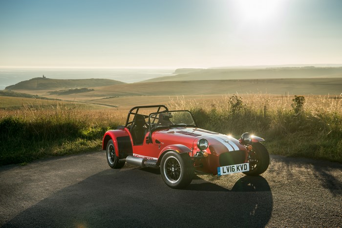 Red Caterham 7 310R on a coastal road