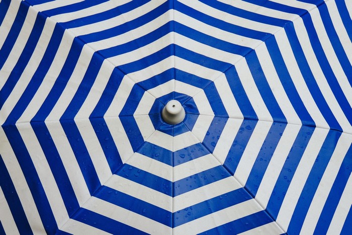 Blue and white striped umbrella close-up