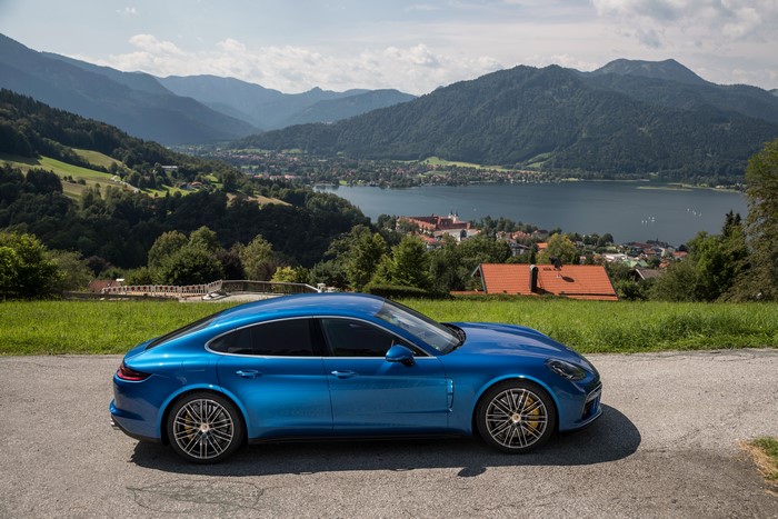 Blue Porsche Panamera Turbo on a scenic mountain road