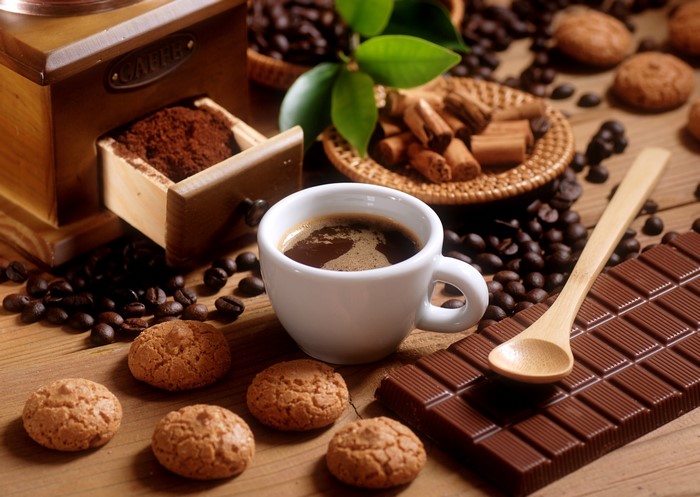 Coffee, cookies, chocolate bar, and coffee grinder