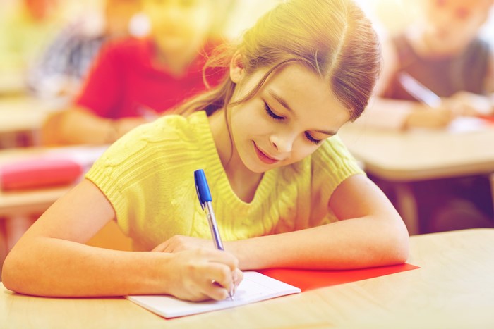 Schoolgirls writing in a classroom