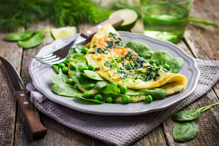 Omelette with spinach and peas on a plate