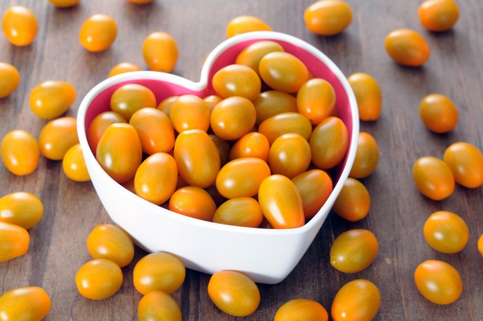 Yellow cherry tomatoes in a heart-shaped bowl