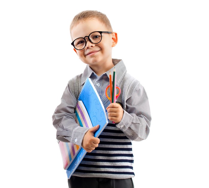 Boy with glasses holding notebooks and pencils
