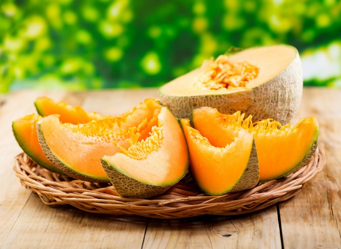 Cantaloupe slices on a woven plate