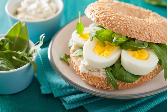 Bagel sandwich with eggs and greens