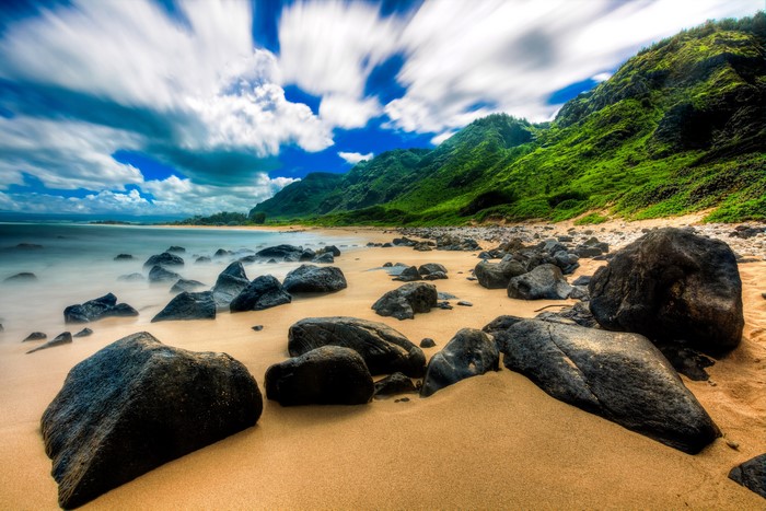 Hawaii Coastline with Green Mountains and Rocky Beach