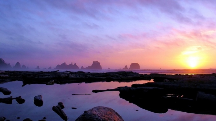 Sunset over rocky coast with tide pools