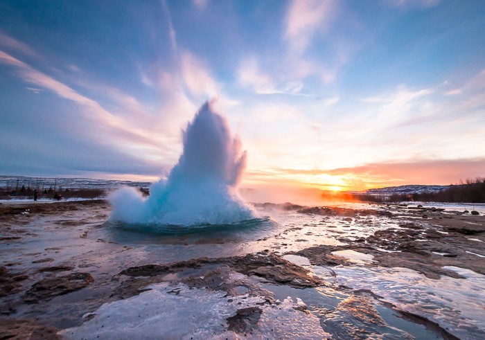 Strokkur Geyser eruption in Iceland at sunset