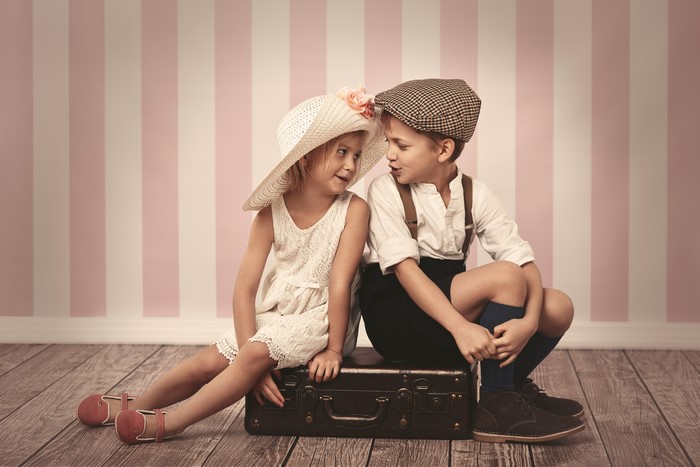 Boy and Girl in Vintage Clothes with Suitcase