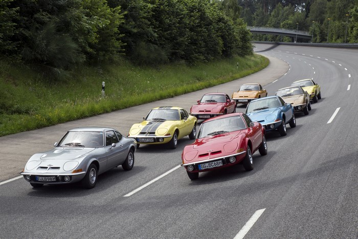 Multiple Opel GT cars driving on a road