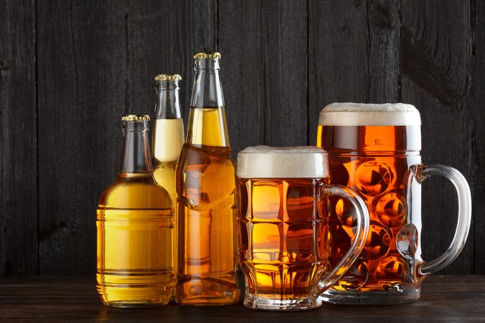 Beer bottles and mugs with foam