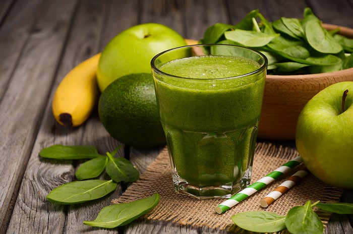 Green smoothie with apples, banana, avocado, and spinach