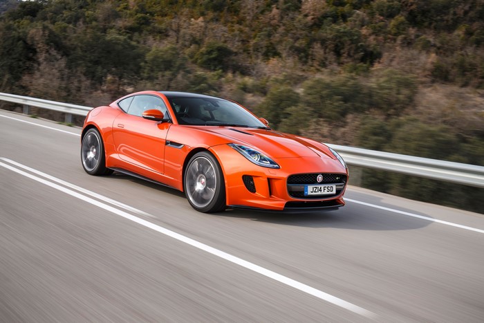 Orange Jaguar F-Type Driving on Road