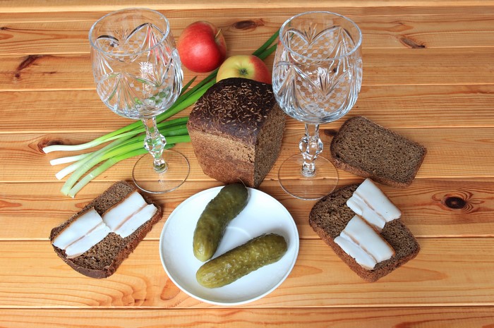 Still-life with bread, cucumbers, apples, salo, and glasses