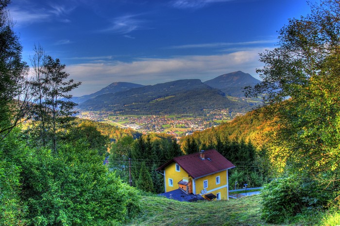 Yellow house in Hallein, Austria with mountains in the background