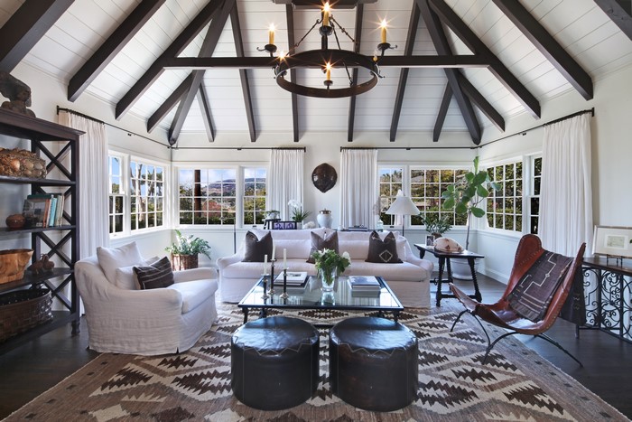 Living room with vaulted ceiling and large windows