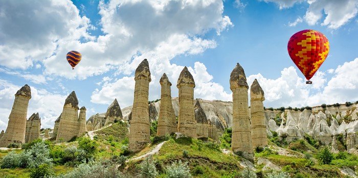 Hot air balloons over rock formations in Goreme National Park, Turkey