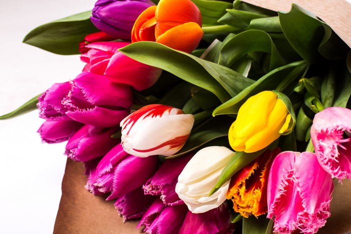 Bouquets of colorful tulips in a brown paper wrap