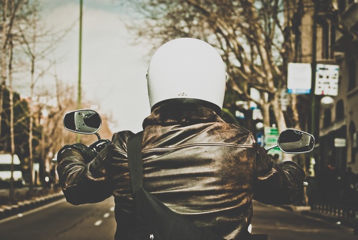 Man in Leather Jacket and Helmet on Motorcycle