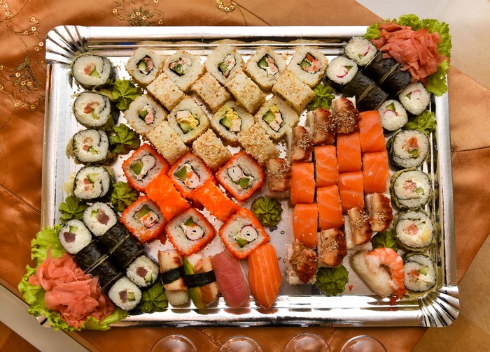 Sushi platter with various rolls and sashimi