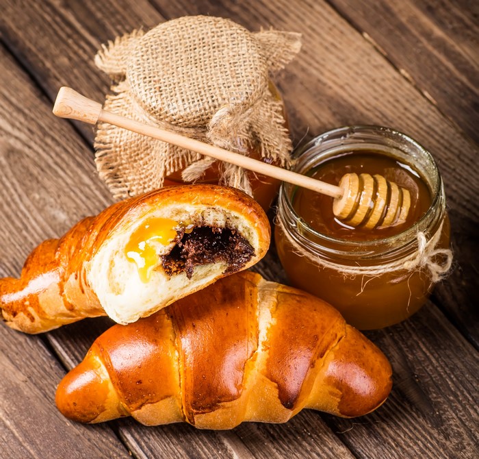 Croissants with chocolate and honey in a jar