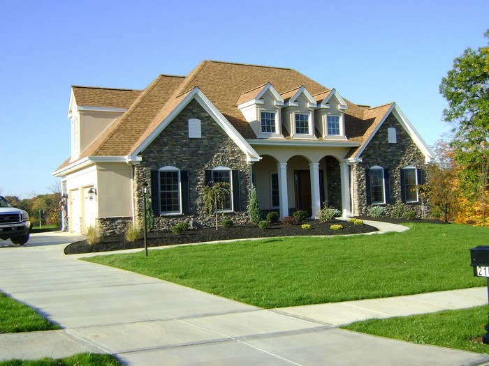 Luxury Stone and Stucco House with Manicured Lawn