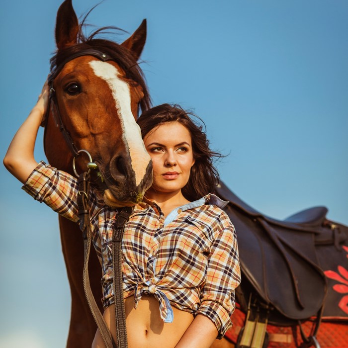 Woman in plaid shirt with horse