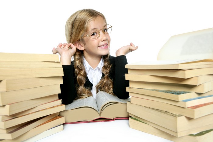 Little girl with glasses and books