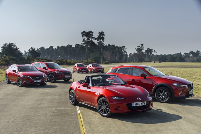 Multiple red Mazda cars parked outdoors