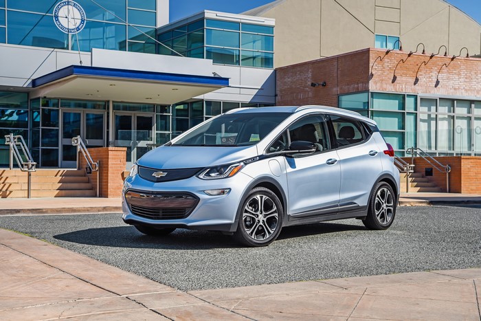 Silver 2017 Chevrolet Bolt EV parked outside building