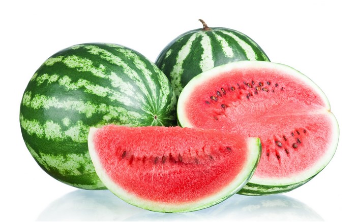 Watermelons and slices on a white background